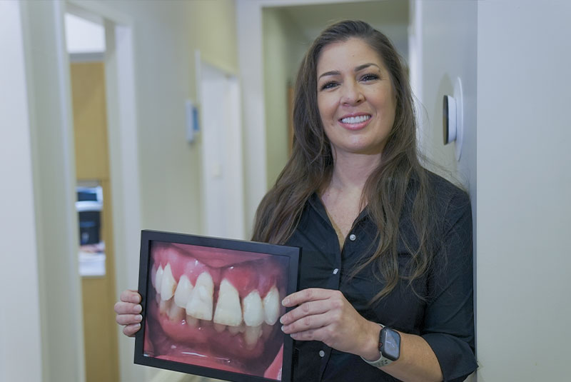 patient showing a before photo of their teeth