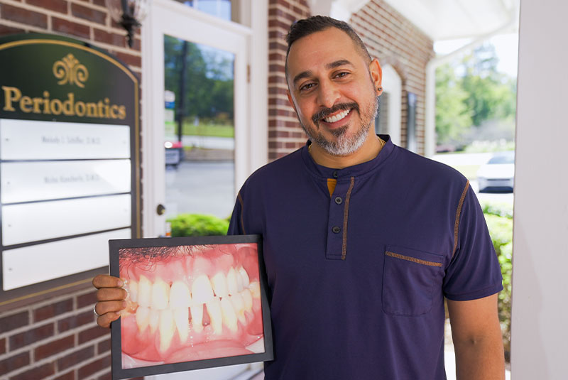 patient showing a before photo of their teeth
