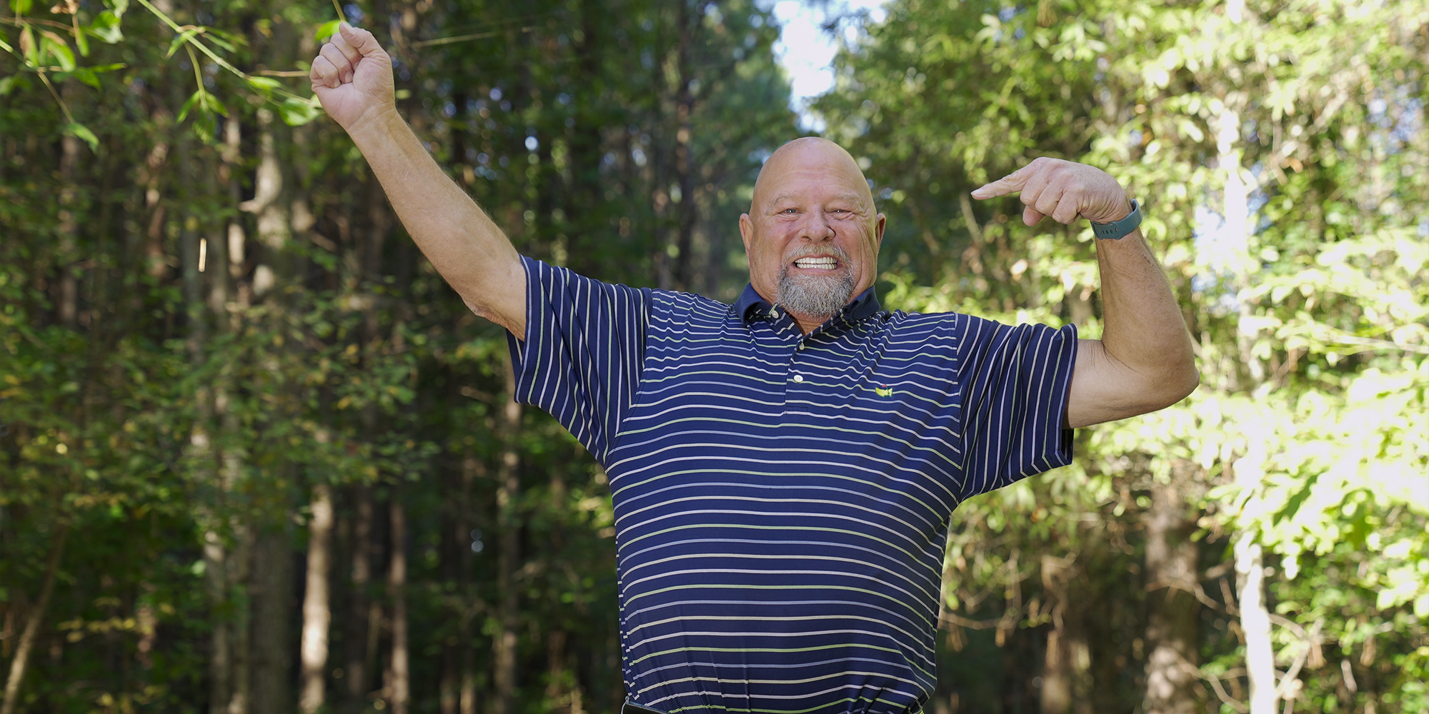 man throwing hands up in the air pointing at his teeth